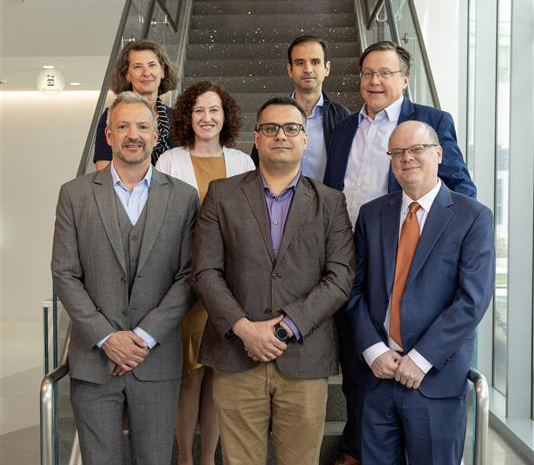 Wellstone leadership team standing on a staircase.