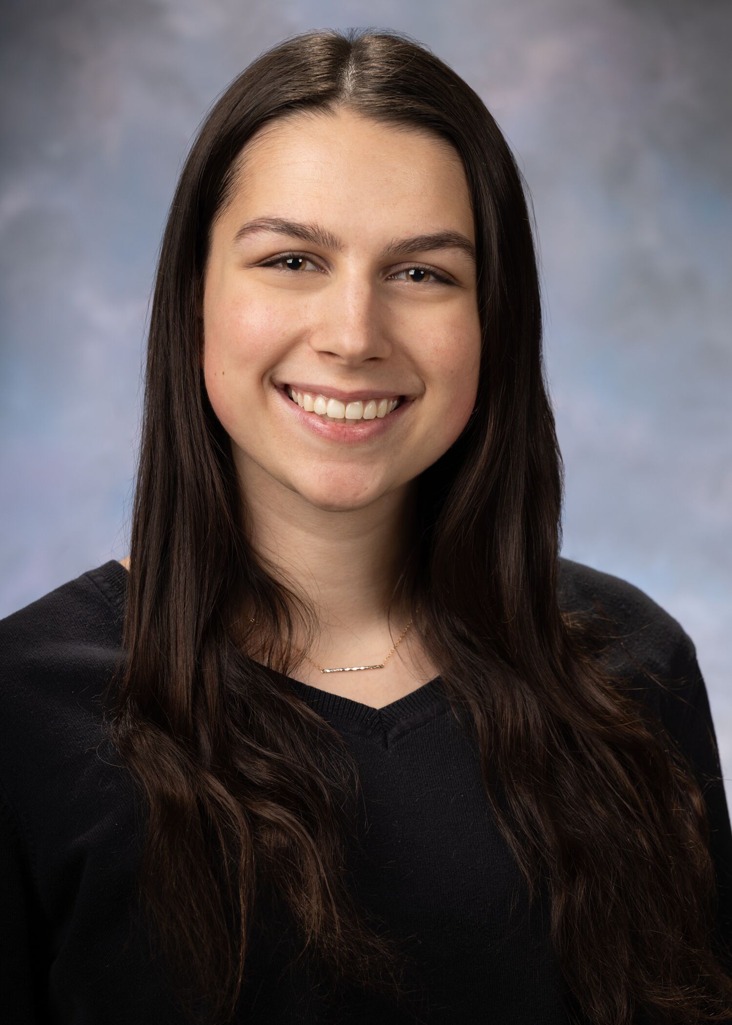 Portrait of Katarina Dunn. Katarina has long dark hair and is wearing a dark long-sleeved shirt. 