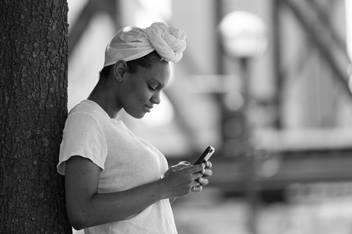 Teen Girl Checking Her Cell Phone Outdoors
