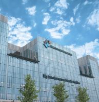 Exterior of Behavioral Health Pavilion with leafy trees and sunny skies