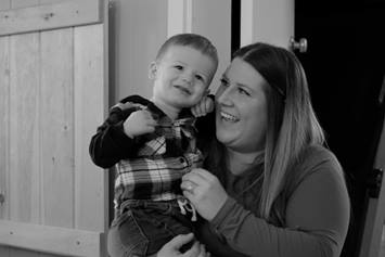 Hayes, a patient at Nationwide Children's Hospital smiling for the camera with his mom.