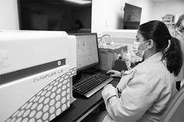 Pathology employee with a Cytoflex machine