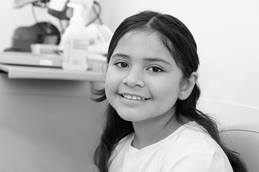 Smiling elementary aged girl in a laboratory setting